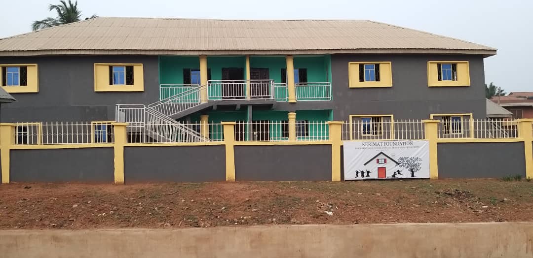 The Kerimat Foundation building in Jattu, Edo State, with the foundation signboard on the perimeter wall